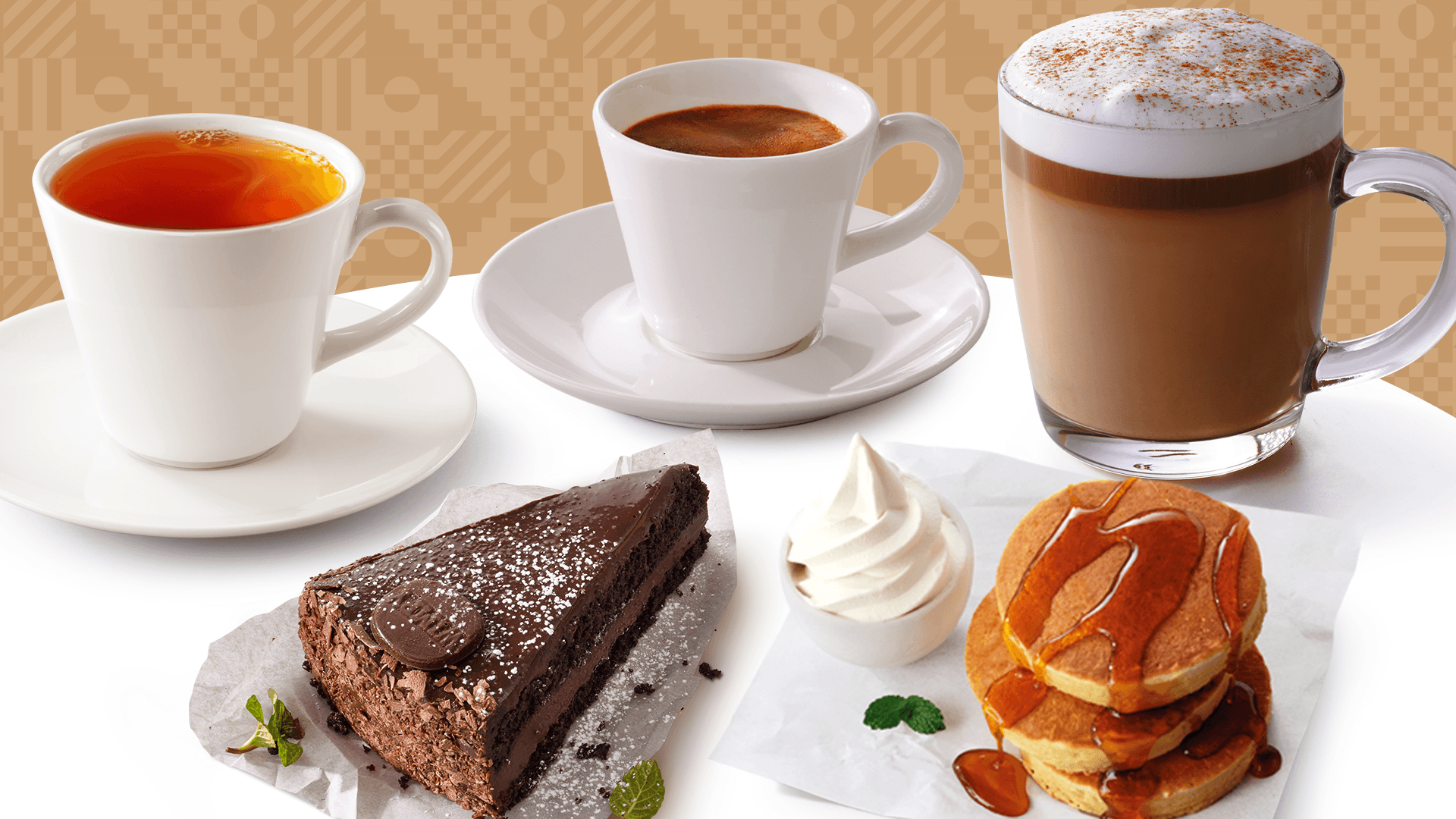 A cup of tea next to a cappuccino, espresso, flapjacks, and a slice of chocolate cake.