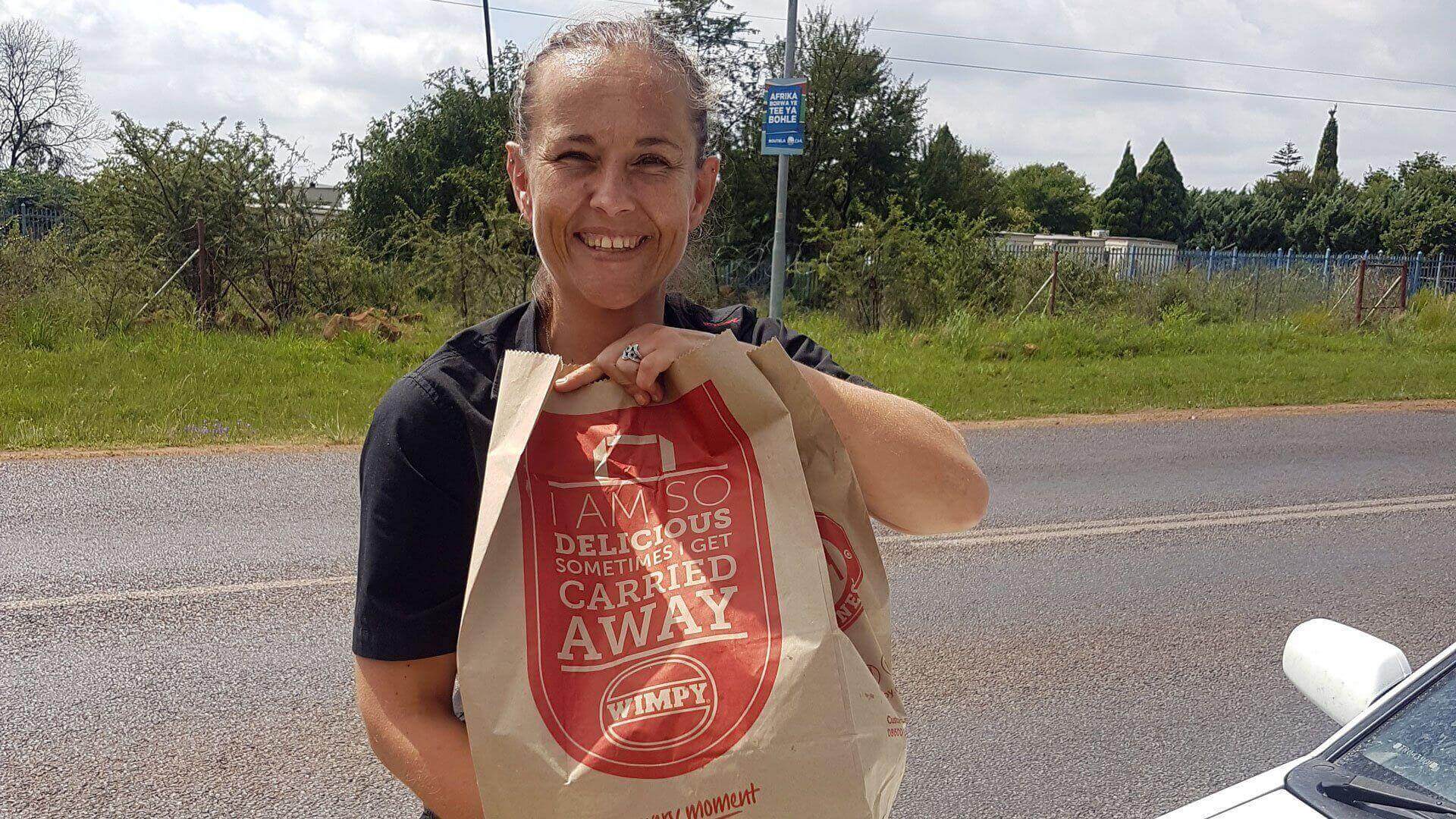 Stephanie Pretoruis holding Wimpy takeaway bag